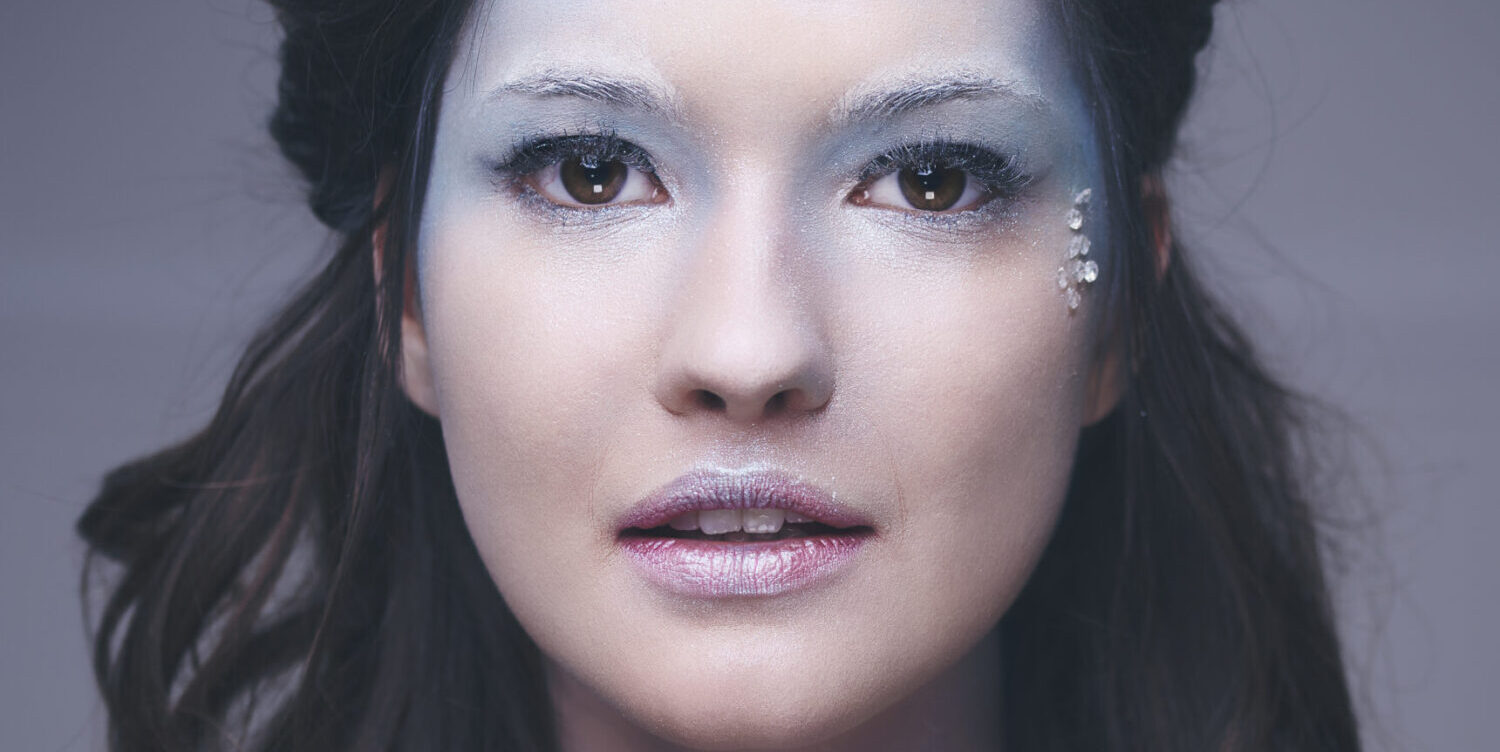 a woman with makeup and eyeshadow